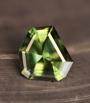A green and teal shield-cut Australian sapphire cut on the property